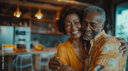 Portrait of a happy retired senior biracial couple smiling at each other at home © Papukos