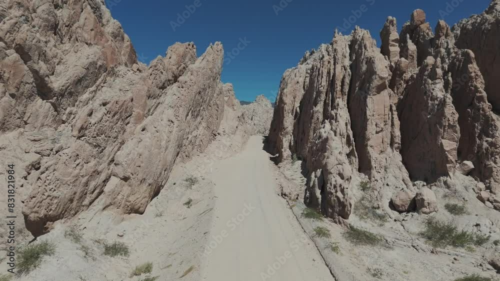 Drone advancing over a stone cliff in the Quebrada de las Flechas, on a beautiful sunny day in the province of Salta, Argentina.