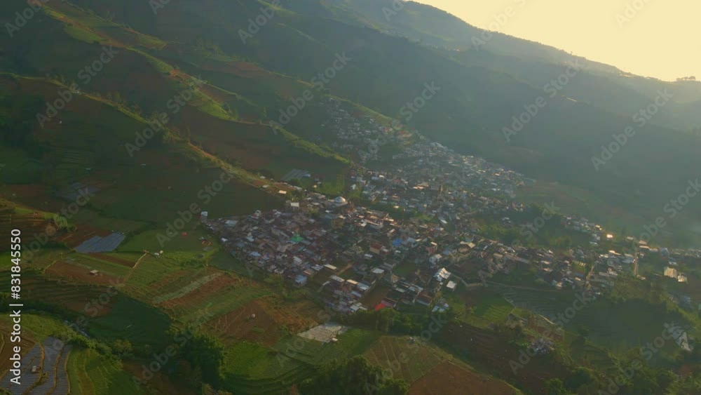 Aerial orbit around small village in the Indonesian countryside on a steep hill