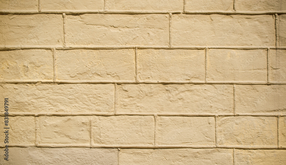Obraz premium Brick wall texture background, sandy yellow color