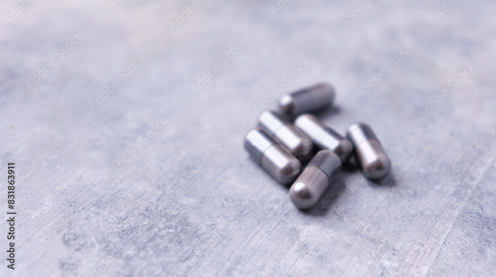 Amino acids capsules on bright stone background. Soft focus. Close up. Copy space. Amino acids capsules on bright stone background. Soft focus. Close up. Copy space.