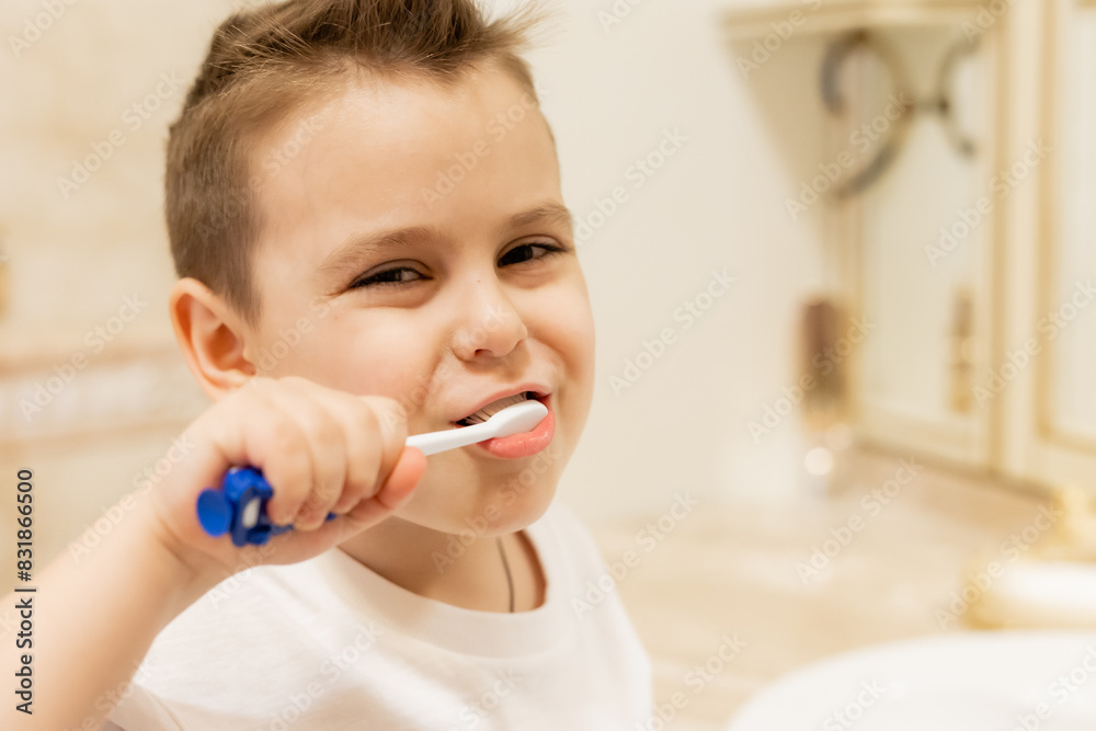 little boy brushes his teeth in the bathroom at home little boy brushes his teeth in the bathroom at home
