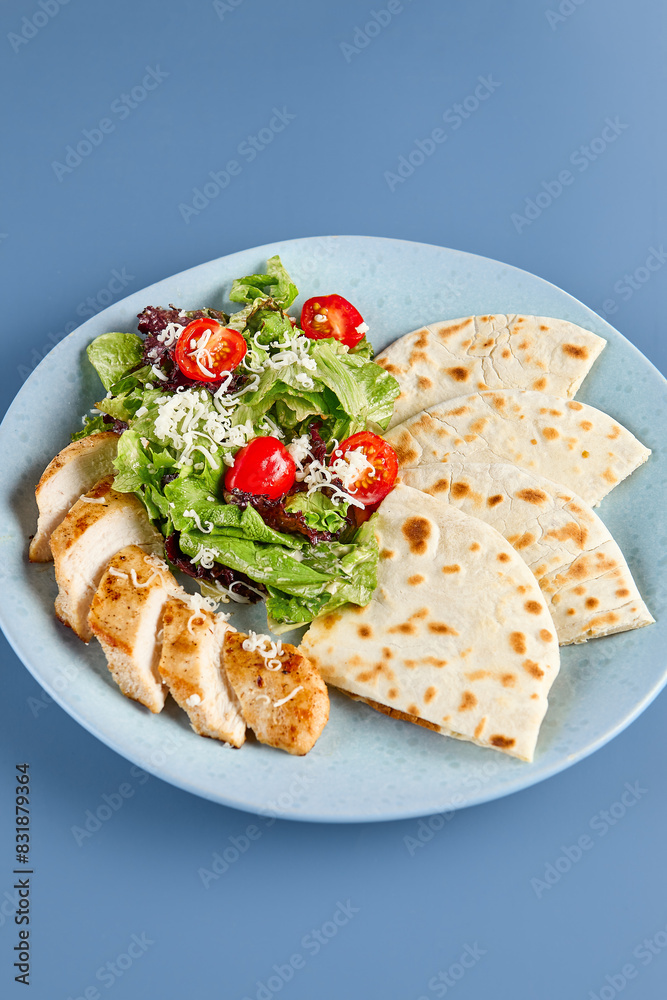 Fresh Chicken Caesar Salad with Tortilla on Blue Plate - Healthy and Delicious Meal Fresh Chicken Caesar Salad with Tortilla on Blue Plate - Healthy and Delicious Meal