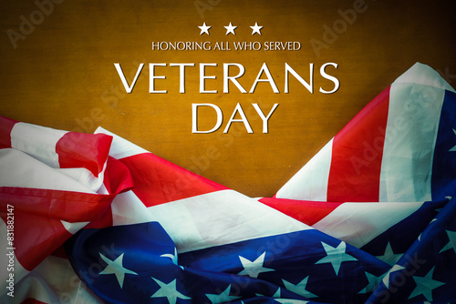American flags with Text Veterans Day Honoring All Who Served on background. American holiday banner.