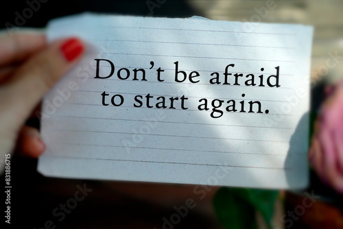 Text message on the thorn paper in hand - Don't be afraid to start again. Life motivational concept with positive motivation words. 