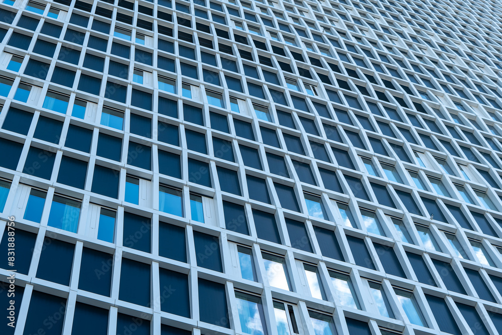 large building with many windows and a blue sky in the background large building with many windows and a blue sky in the background