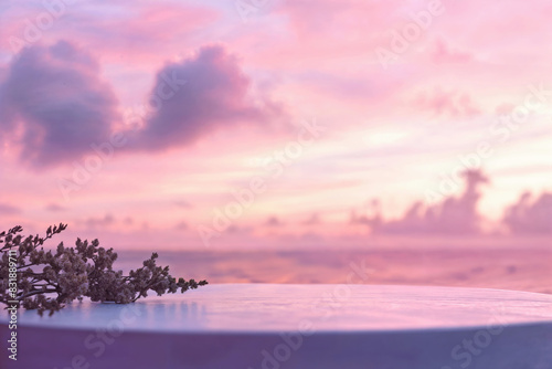 Flower sprig on table with pink and purple sunset sky. Design for poster, greeting card, invitation, postcard, banner.