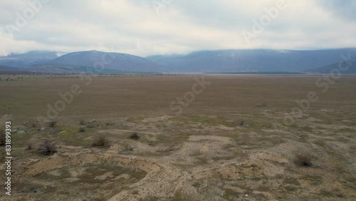 A beautiful landscape drone video of an empty field with a road in Croatia region Lika in Europe (ID: 831899393)