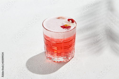Fotografie Aesthetic composition with alcoholic cocktail with flowers on white background
