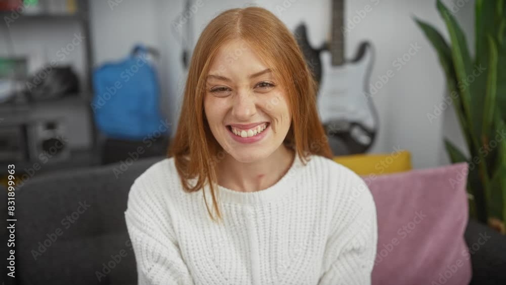 Excited young redhead woman with a cool, confident smile, lucky and cheerful in her cozy home, wearing a sweater. happiness and success in her natural, perfect lifestyle. Excited young redhead woman with a cool, confident smile, lucky and cheerful in her cozy home, wearing a sweater. happiness and success in her natural, perfect lifestyle.