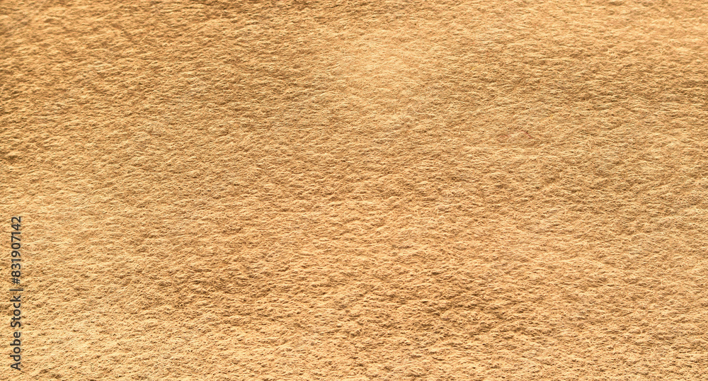Yellow brown felt texture abstract background. Surface of fabric texture in brown color. Yellow brown felt texture abstract background. Surface of fabric texture in brown color.