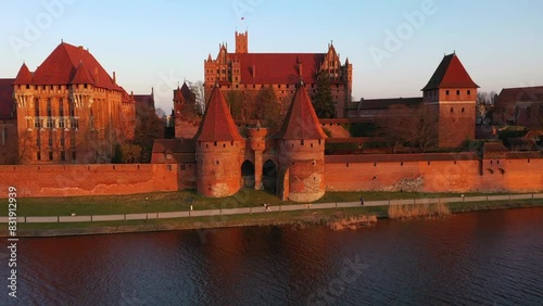Malbork castle over the Nogat river at sunset, Poland photo