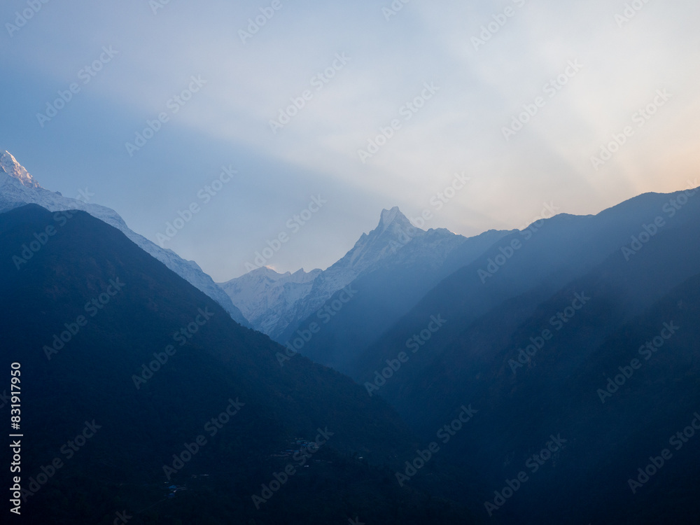Sun is illuminating mountains above valley Sun is illuminating mountains above valley