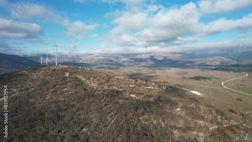 Beautiful aerial shot of Croatian landscape with wind turbines generating renewable energy in the region of Lika in Croatia, Europe (ID: 831927954)