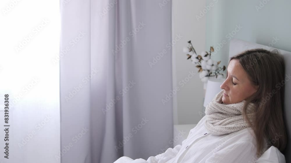 Sick woman lying in bed in bedroom, wearing scarf for warmth. Woman with scarf resting, showing signs of illness. Ideal for health-related content, featuring cozy scene with scarf. Sick woman lying in bed in bedroom, wearing scarf for warmth. Woman with scarf resting, showing signs of illness. Ideal for health-related content, featuring cozy scene with scarf.