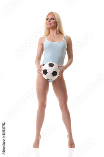 woman wearing swim suit and holding soccer ball