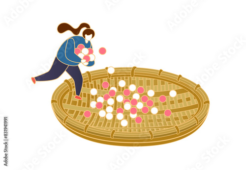 Woman rolls yuan xiao with a big bamboo sieve