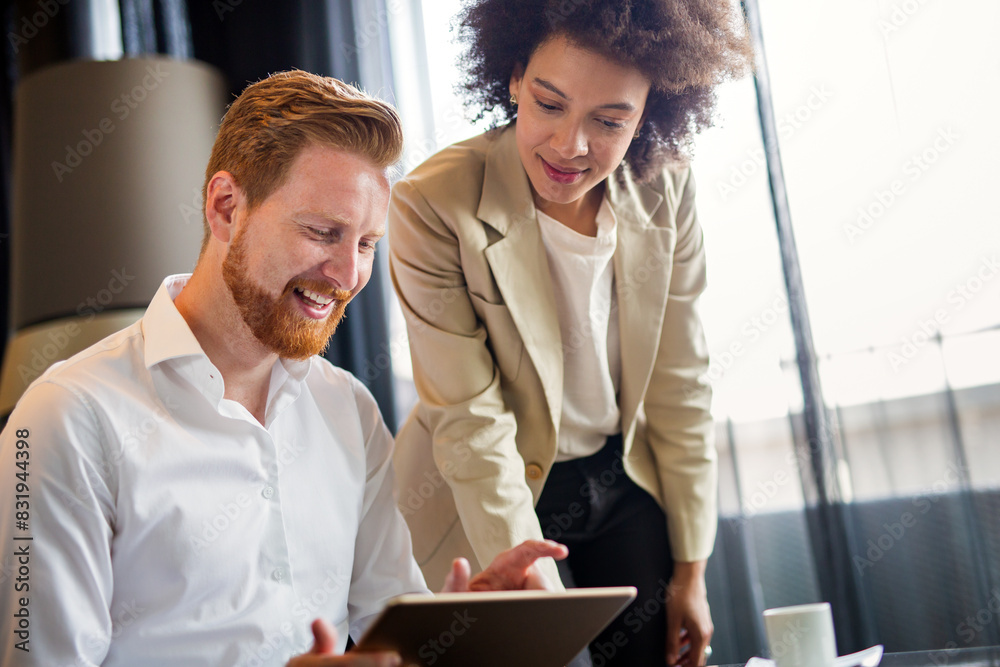 © NDABCREATIVITY - Corporate multiethnic business people project team working together at meeting room at office.