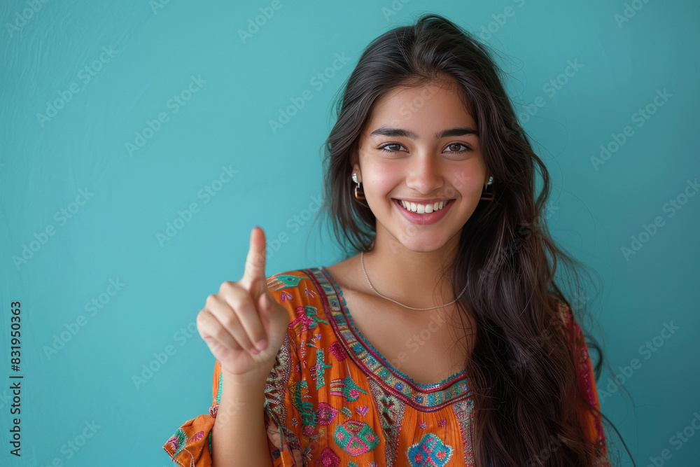 young woman smiling and pointing finger young woman smiling and pointing finger