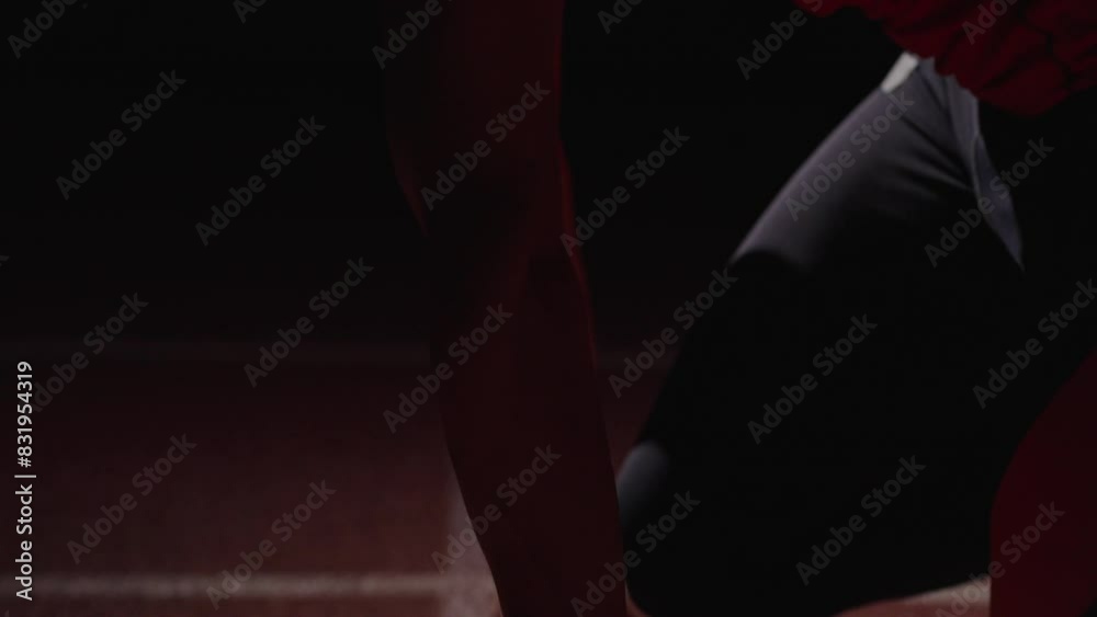 Closeup Of Hands And Face Of Professional Runner In Low Start Position On Running Track In Stadium Closeup Of Hands And Face Of Professional Runner In Low Start Position On Running Track In Stadium