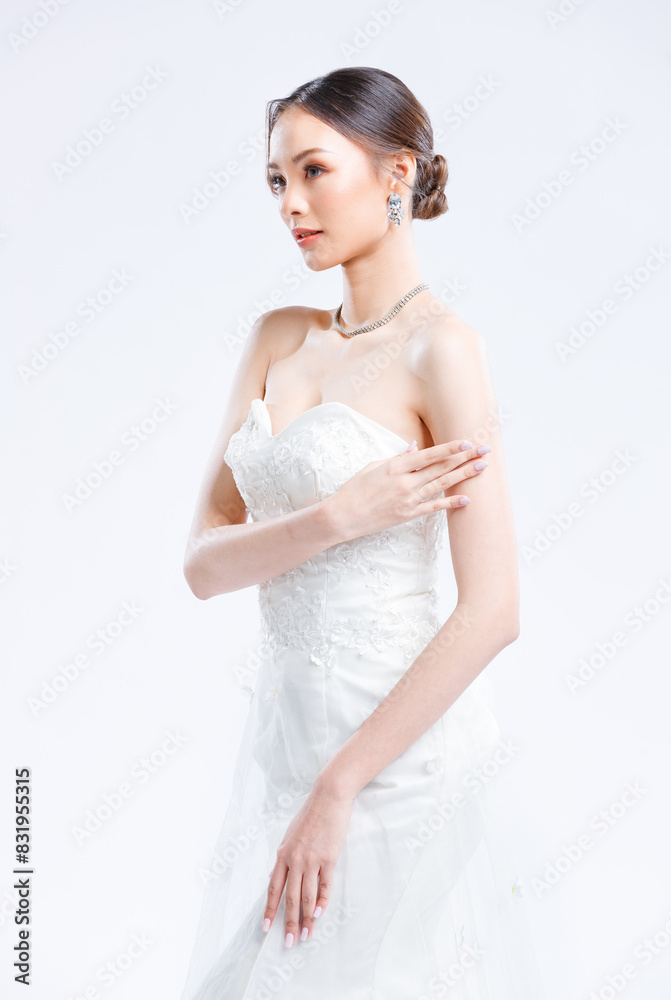 Asian young beautiful female portrait attractive model gorgeous charming bride wearing fashion wedding dress luxury perfect style, posing standing smile looking camera isolated white background studio Asian young beautiful female portrait attractive model gorgeous charming bride wearing fashion wedding dress luxury perfect style, posing standing smile looking camera isolated white background studio