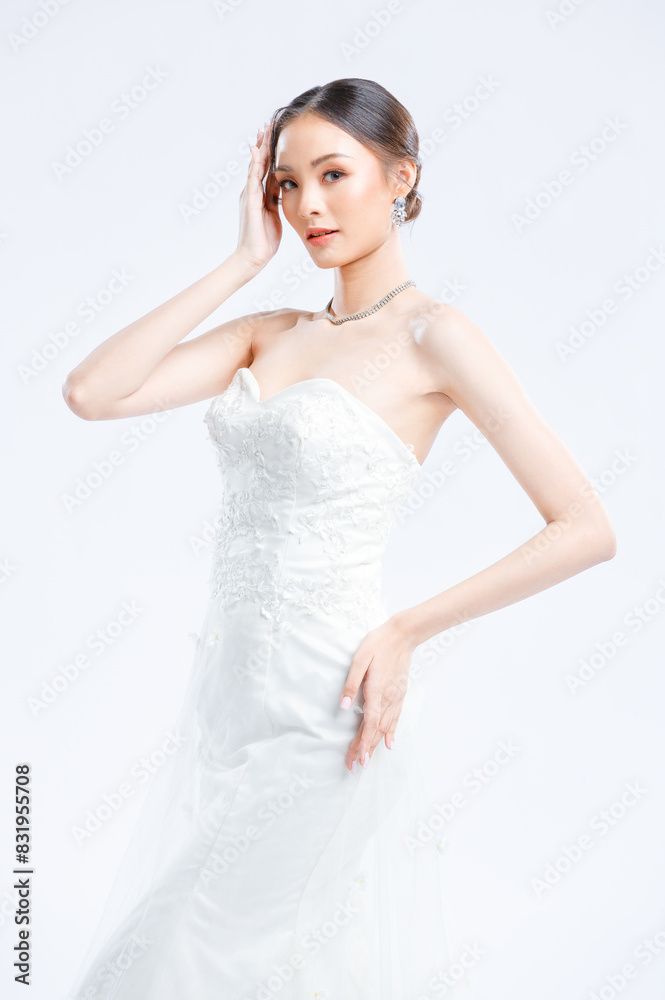 Asian young beautiful female portrait attractive model gorgeous charming bride wearing fashion wedding dress luxury perfect style, posing standing smile looking camera isolated white background studio Asian young beautiful female portrait attractive model gorgeous charming bride wearing fashion wedding dress luxury perfect style, posing standing smile looking camera isolated white background studio