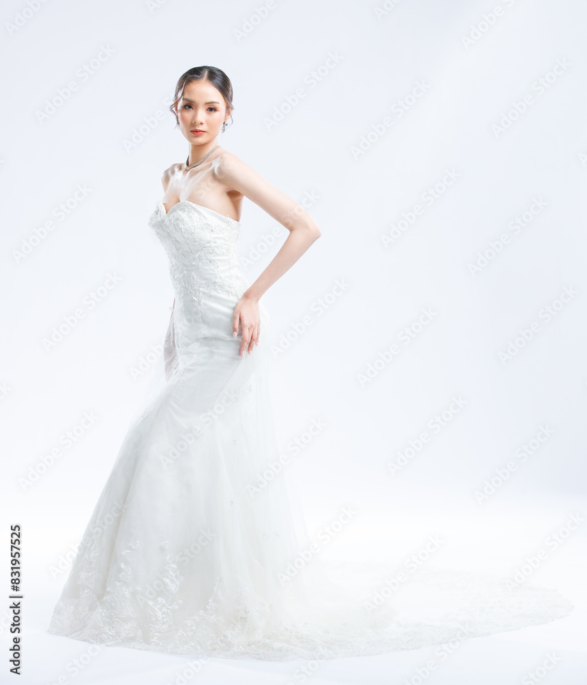 Asian young beautiful female portrait attractive model gorgeous charming bride wearing fashion wedding dress luxury perfect style, posing standing smile looking camera isolated white background studio Asian young beautiful female portrait attractive model gorgeous charming bride wearing fashion wedding dress luxury perfect style, posing standing smile looking camera isolated white background studio