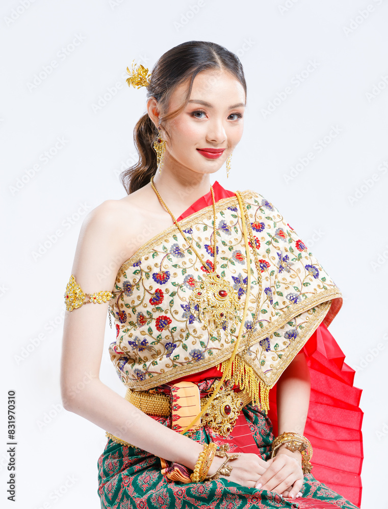 Half body shot, Asian young female portrait beautiful bride woman in vintage traditional Thai costumes, gold and red color dress, sitting smile looking camera isolated white background studio. Half body shot, Asian young female portrait beautiful bride woman in vintage traditional Thai costumes, gold and red color dress, sitting smile looking camera isolated white background studio.
