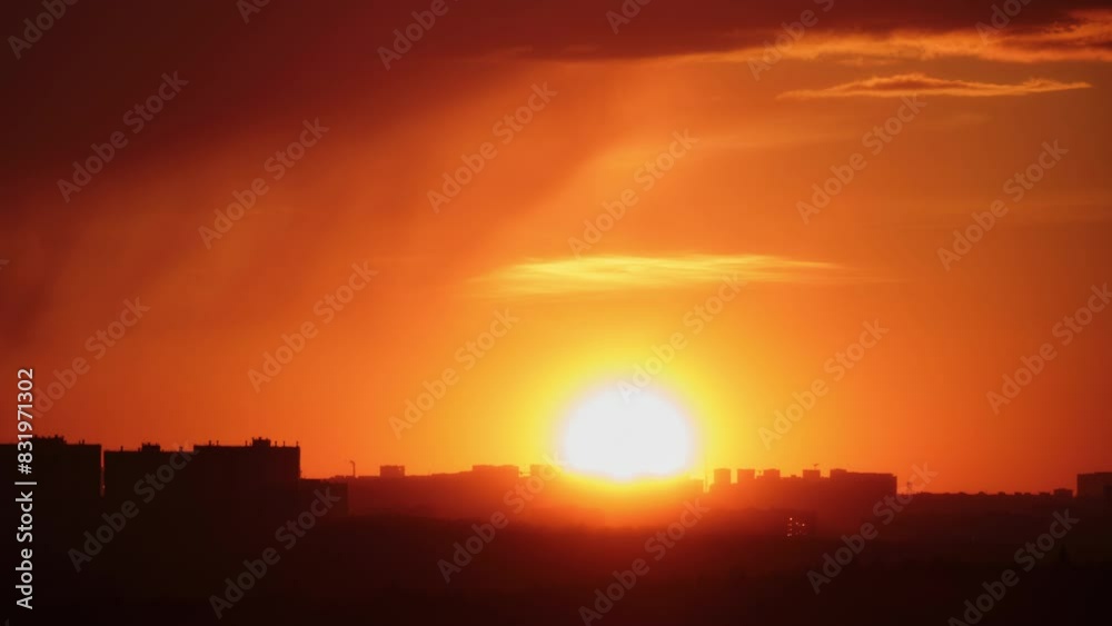 The cityscape at sunset was breathtaking, with red clouds and tall buildings silhouetted against the sky, time lapse