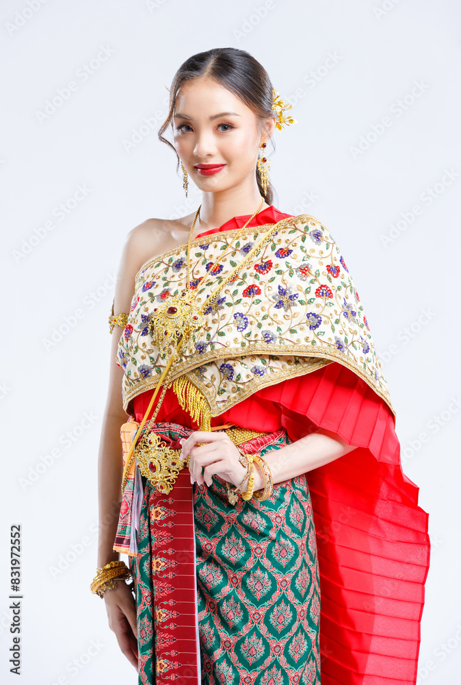 Asian young female portrait beautiful bride woman in vintage traditional Thai costumes, gold and red color dress, standing smile looking camera isolated white background studio Asian young female portrait beautiful bride woman in vintage traditional Thai costumes, gold and red color dress, standing smile looking camera isolated white background studio