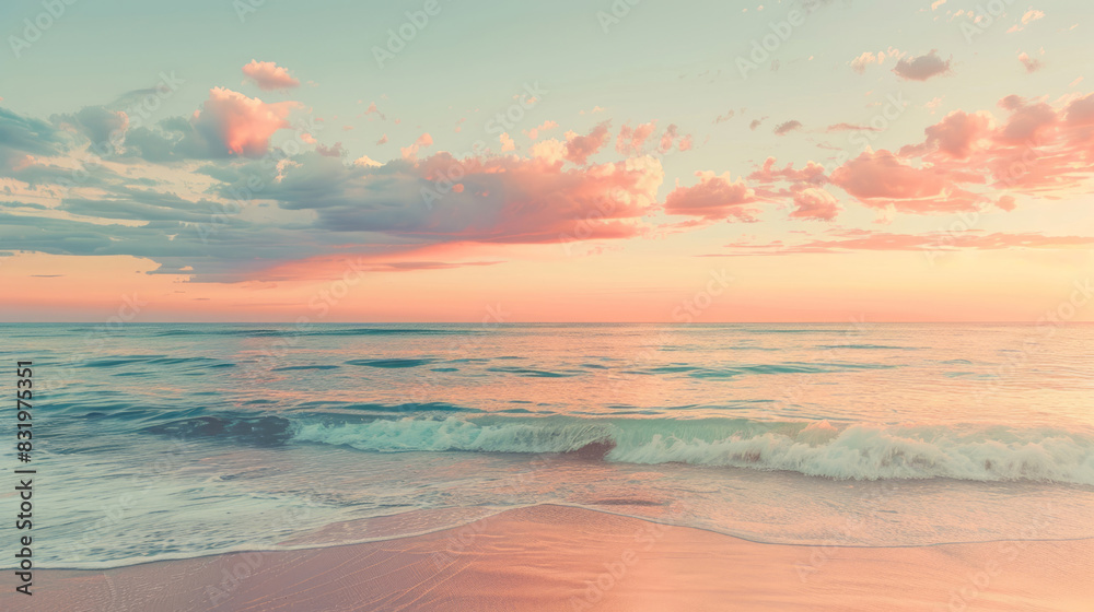 Fototapeta premium A beautiful beach under a pink and orange sunset sky features a calm sea and a sandy shore.