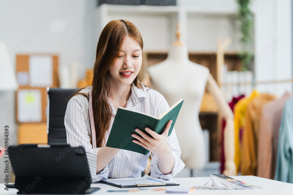 A young Asian businesswoman efficiently manages SMEs, utilizing her desk, tablet, laptop to handle online orders and live streams, showcasing entrepreneurial prowess in the dynamic market landscape. A young Asian businesswoman efficiently manages SMEs, utilizing her desk, tablet, laptop to handle online orders and live streams, showcasing entrepreneurial prowess in the dynamic market landscape.
