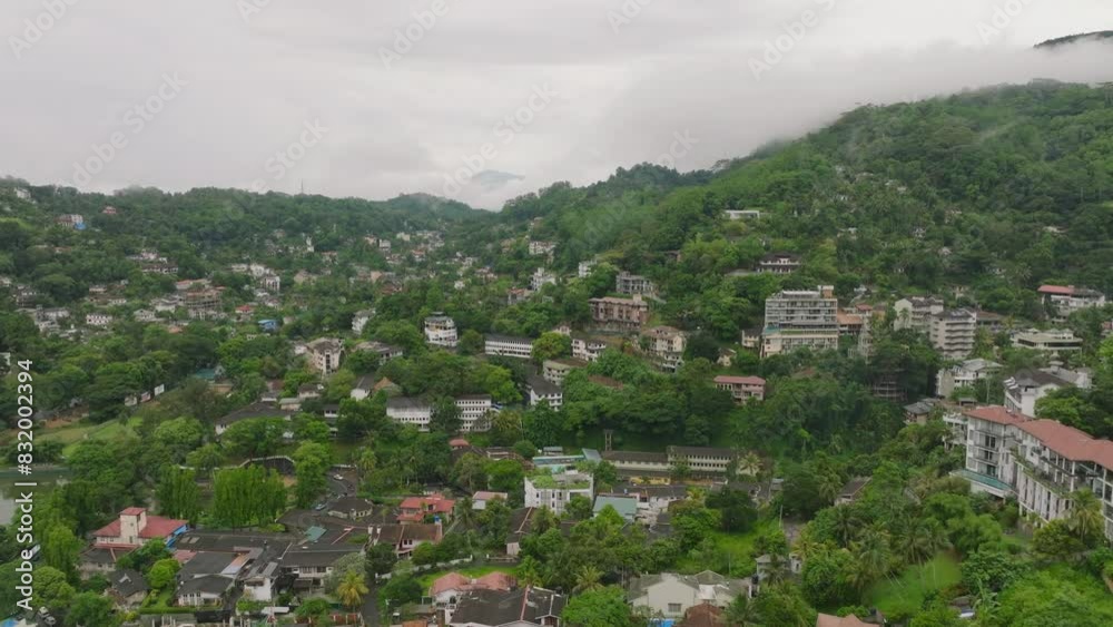 Aerial view of kandy, sri lanka, showing lush greenery and residential buildings in hilly terrain. Cityscape and natural beauty of a famous asian city Aerial view of kandy, sri lanka, showing lush greenery and residential buildings in hilly terrain. Cityscape and natural beauty of a famous asian city
