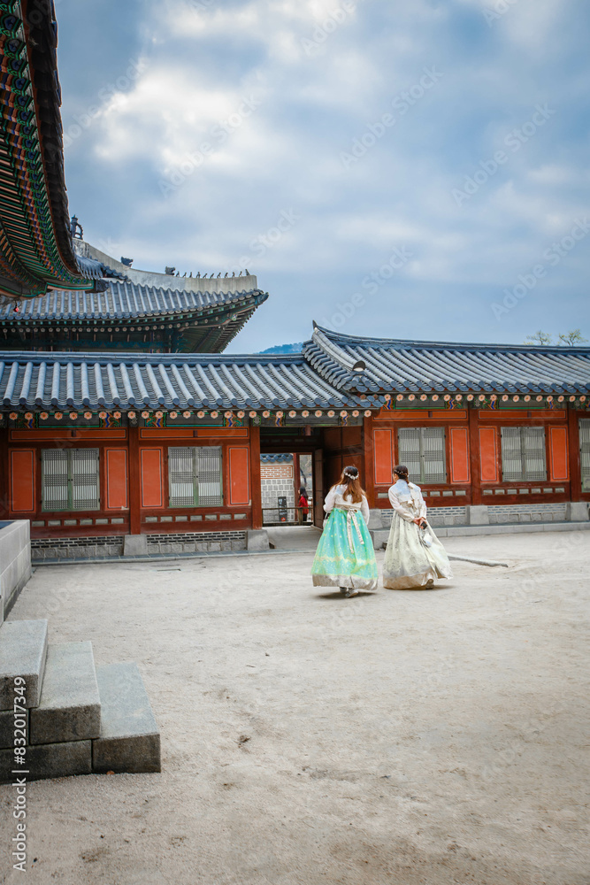 Tourists in national clothes walk in Gyeongbokgung Palace