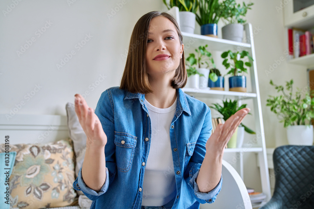 Web cam view of young attractive woman talking in home interior Web cam view of young attractive woman talking in home interior