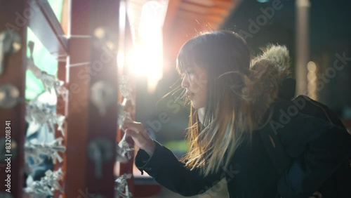 Asian woman enjoy outdoor lifestyle travel at Sensoji Temple and Asakusa district in Tokyo, Japan at night. People tourist travel Japan landmark famous place walking city street on holiday vacation.