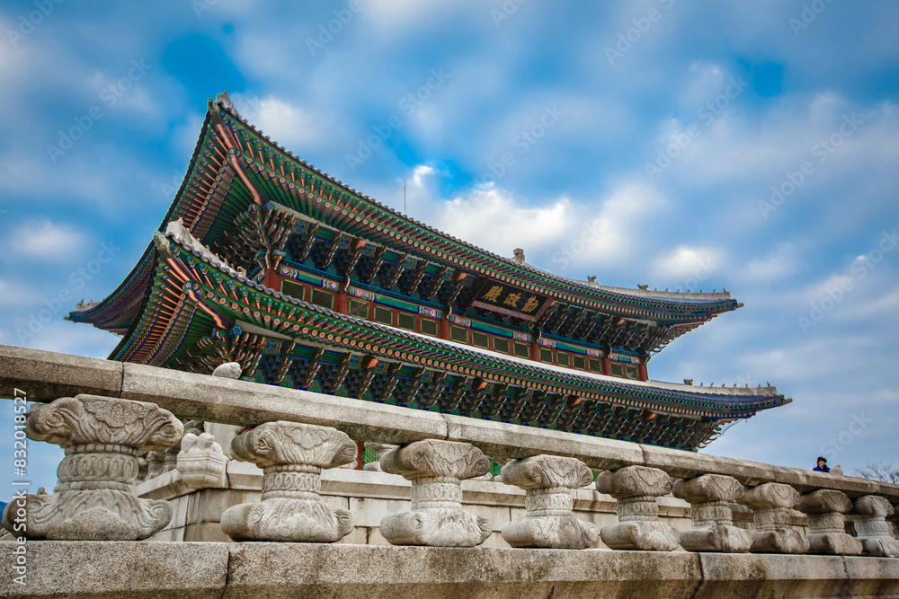 Low angle view of colorful patterned gyeongbokgung roof against sky