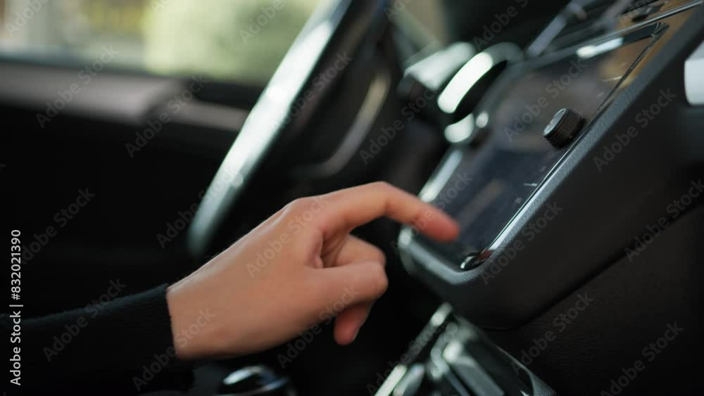 Woman Touches Buttons In The Dashboard Of Her Car Woman Touches Buttons In The Dashboard Of Her Car