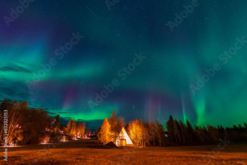 Amazing northern lights dancing over the light up Tipi or Tepees at Aurora Village in Yellowknife, Northwest Territories, Canada.