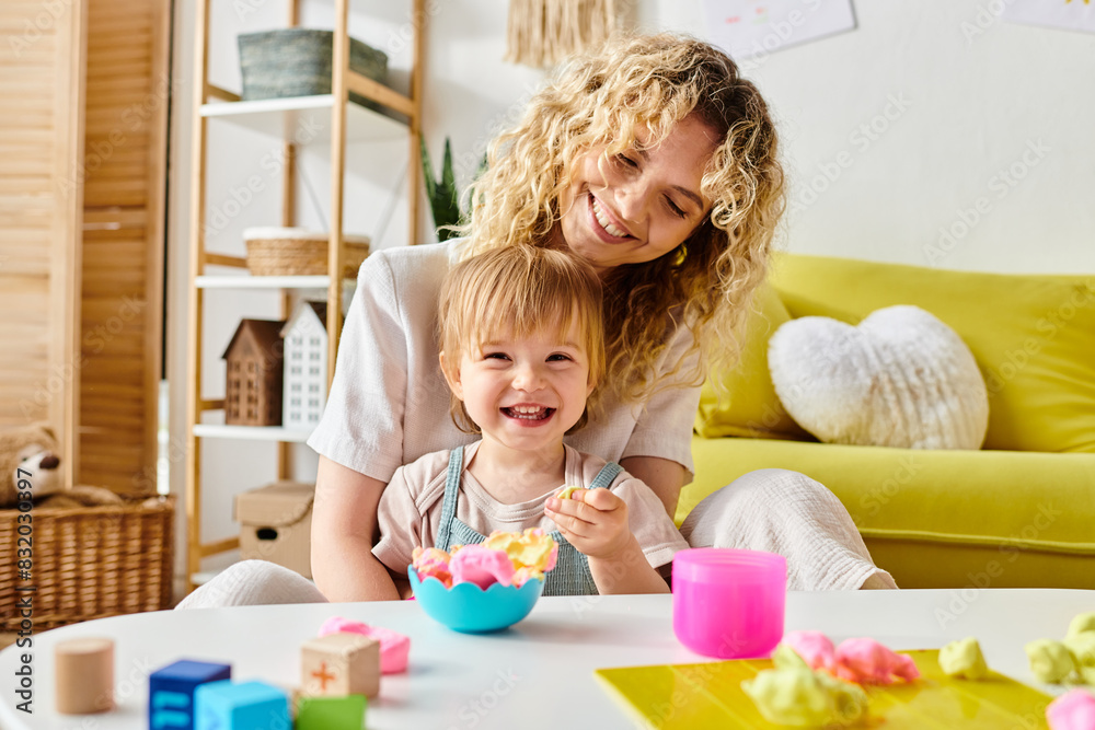 A curly mother and her toddler daughter engage in Montessori learning at a cozy table, exploring new discoveries. A curly mother and her toddler daughter engage in Montessori learning at a cozy table, exploring new discoveries.