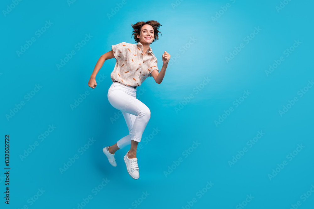 Full length photo of glad positive funny girl running fast empty space empty space isolated on blue color background Full length photo of glad positive funny girl running fast empty space empty space isolated on blue color background