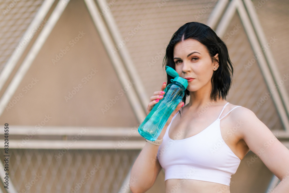 Workout, hydration and a sports woman drinking water outdoor in the city during running and fitness exercise. Hydrated with a female athlete training in an urban town for health. Sport concept. Workout, hydration and a sports woman drinking water outdoor in the city during running and fitness exercise. Hydrated with a female athlete training in an urban town for health. Sport concept.