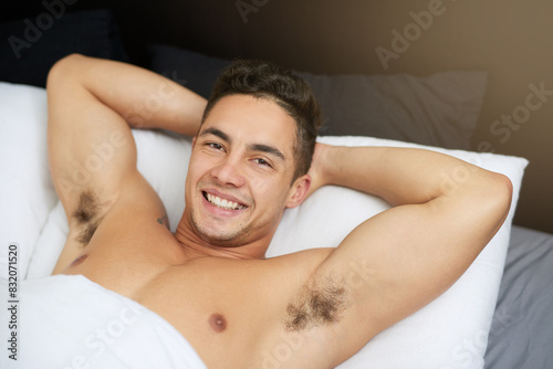 Relax man  bed and portrait in home at morning with confidence and smile after sleeping  nap and student. House  bedroom and happy face on mattress waking up from rest on comfy linen with a break