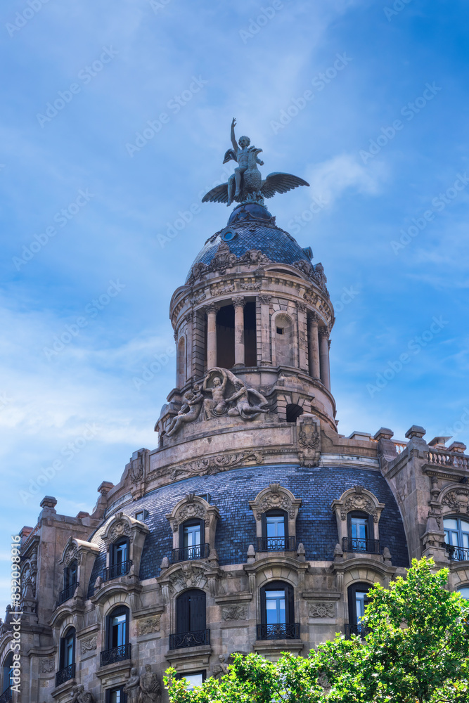 Edifici de la Union y El Fenix Espanol building exterior view with sculpture on rooftop, Barcelona, Catalonia, Spain Edifici de la Union y El Fenix Espanol building exterior view with sculpture on rooftop, Barcelona, Catalonia, Spain