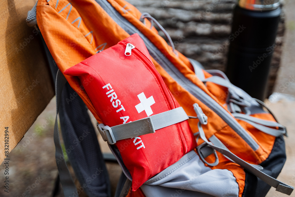 Naklejka premium Outdoor Adventure Backpack with an Essential First Aid Kit is great for hiking and camping. Ensure safety with this backpacks supplies for emergency situations in the wilderness