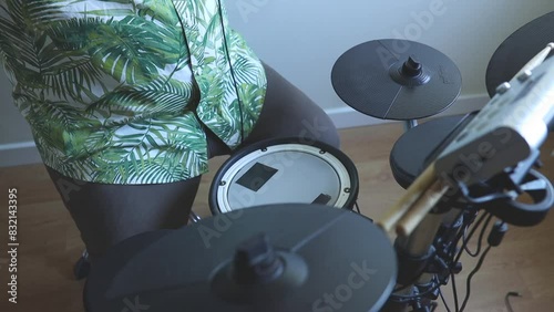 serious male drummer playing electronic drum kit at home. Rock music performance. 