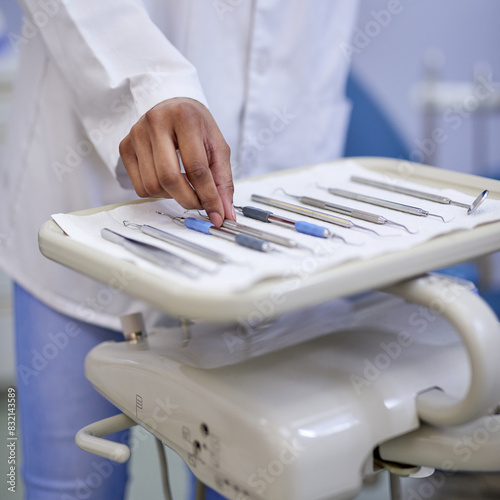 Hands, dentist and pick up tools for surgery, healthcare and treatment with excavator in medical clinic. Dental, equipment and woman with set for orthodontics, oral hygiene and cleaning for wellness