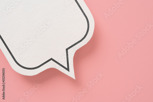 For conceptual image about communication and social media, customer feedback, part of real blank white speech bubble paper cut on pink color background