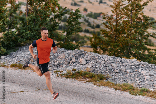 Determined Athlete Running Through Rugged Mountain Terrain at Sunrise. © .shock