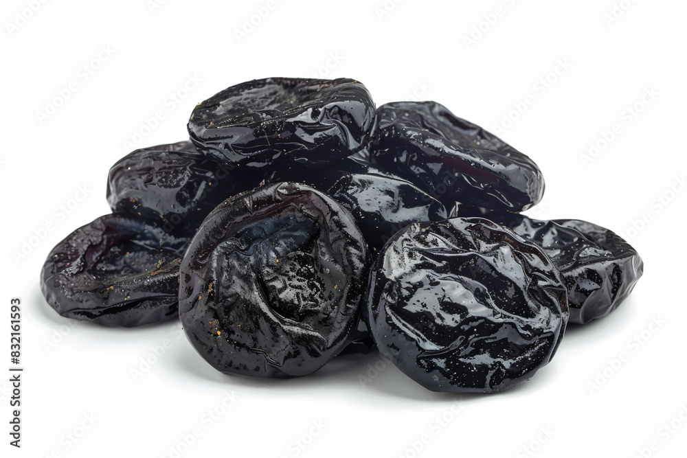 a pile of dried prunes on a white surface a pile of dried prunes on a white surface